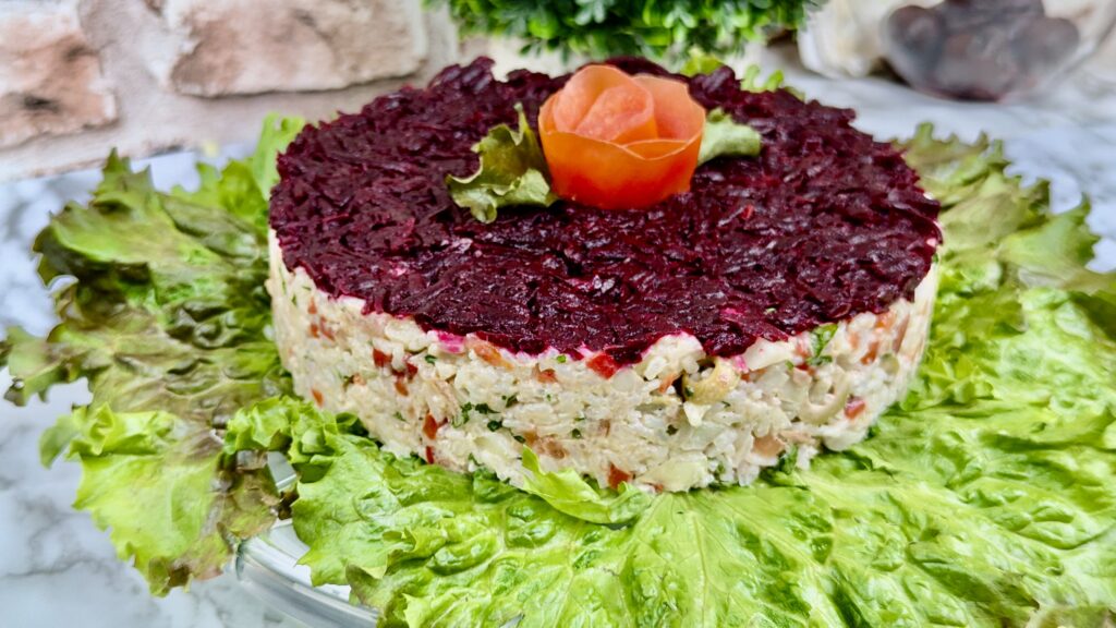 Rice salad with tuna and vegetables decorated with beetroot